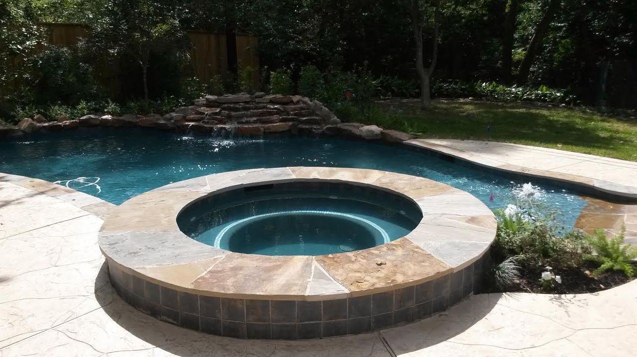 There is a hot tub in the middle of the pool.