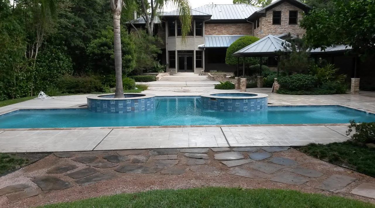 A large house with a large swimming pool in front of it.