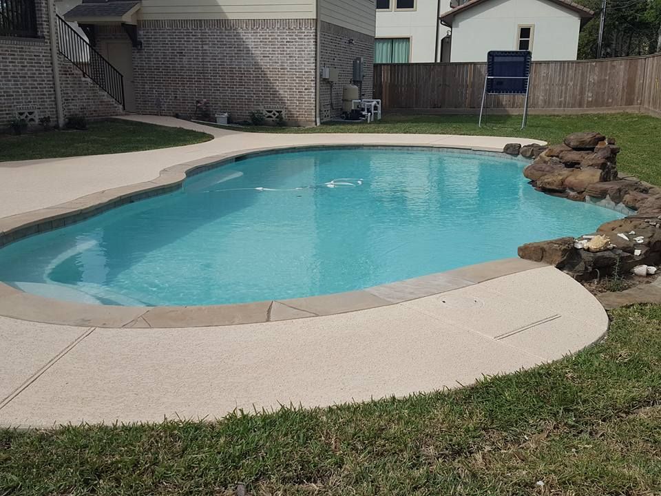 A large swimming pool in the backyard of a house