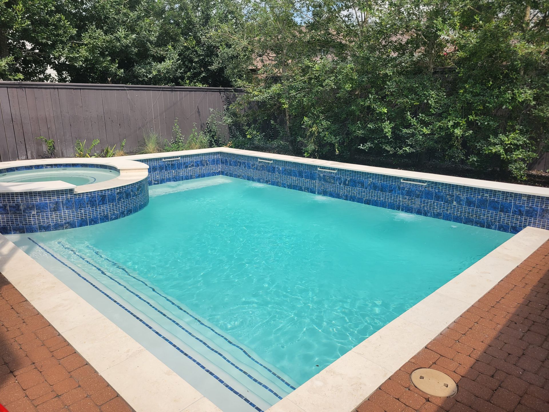 A swimming pool with a bucket on the side of it.