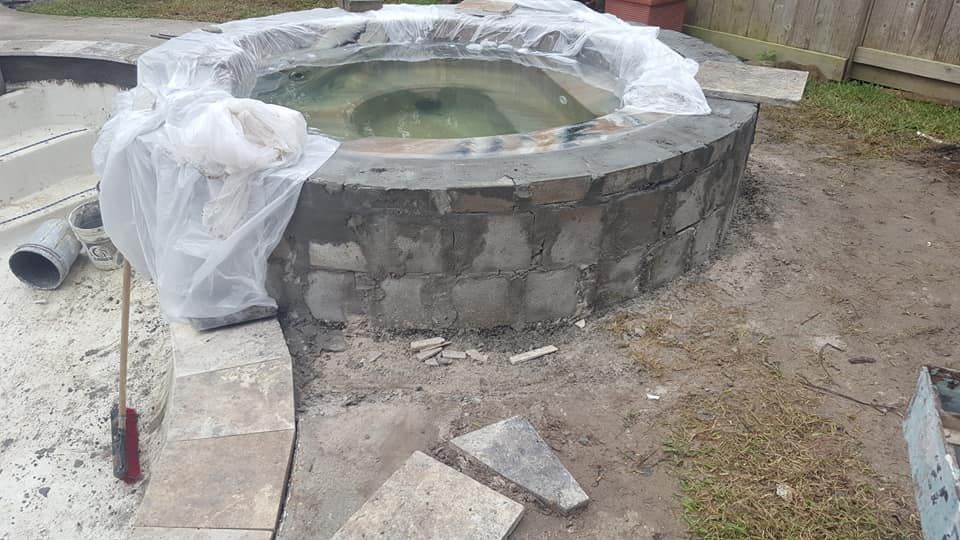 A hot tub is being built in a backyard.