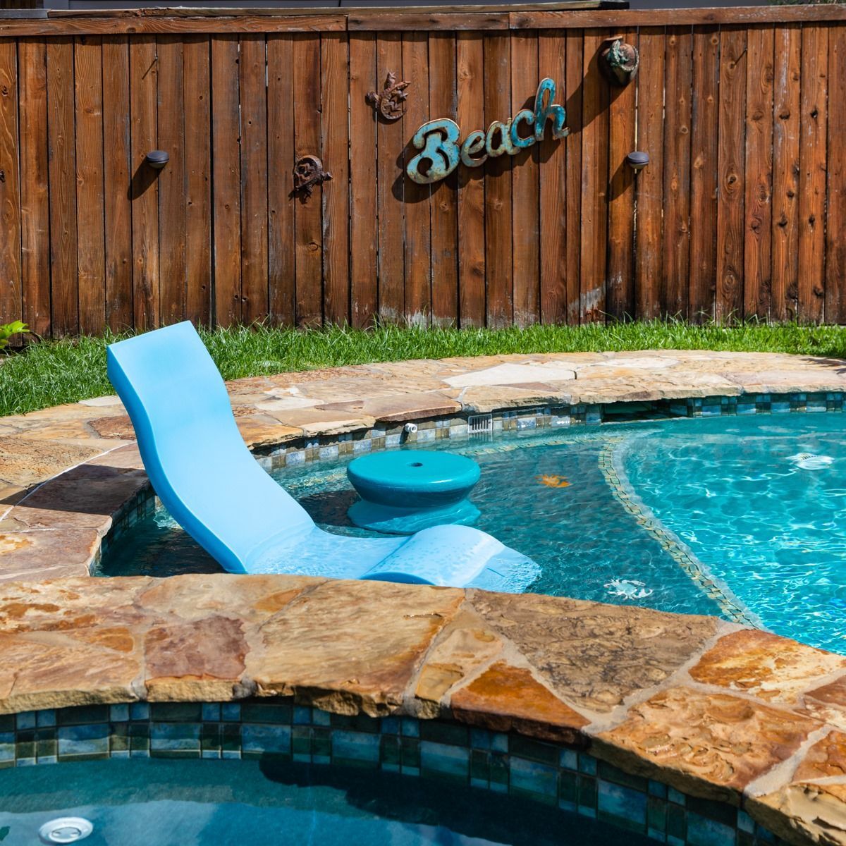 A pool with a sign that says beach on it