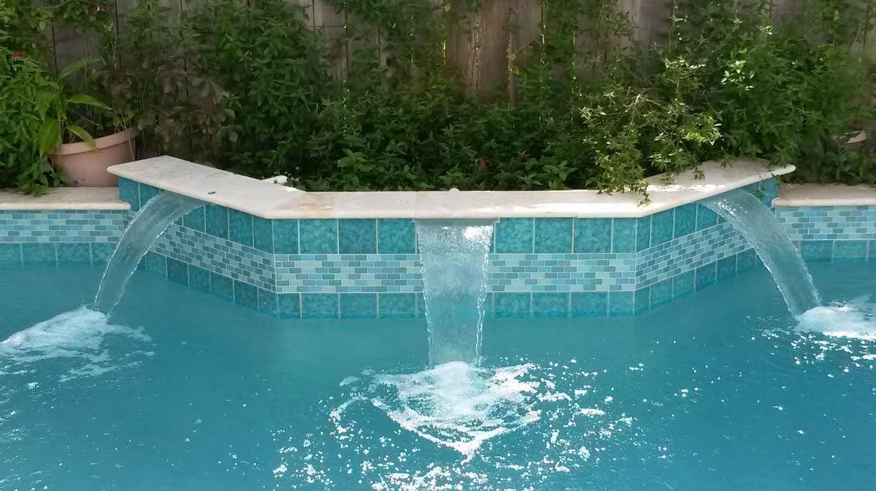 There is a waterfall in the middle of the pool.