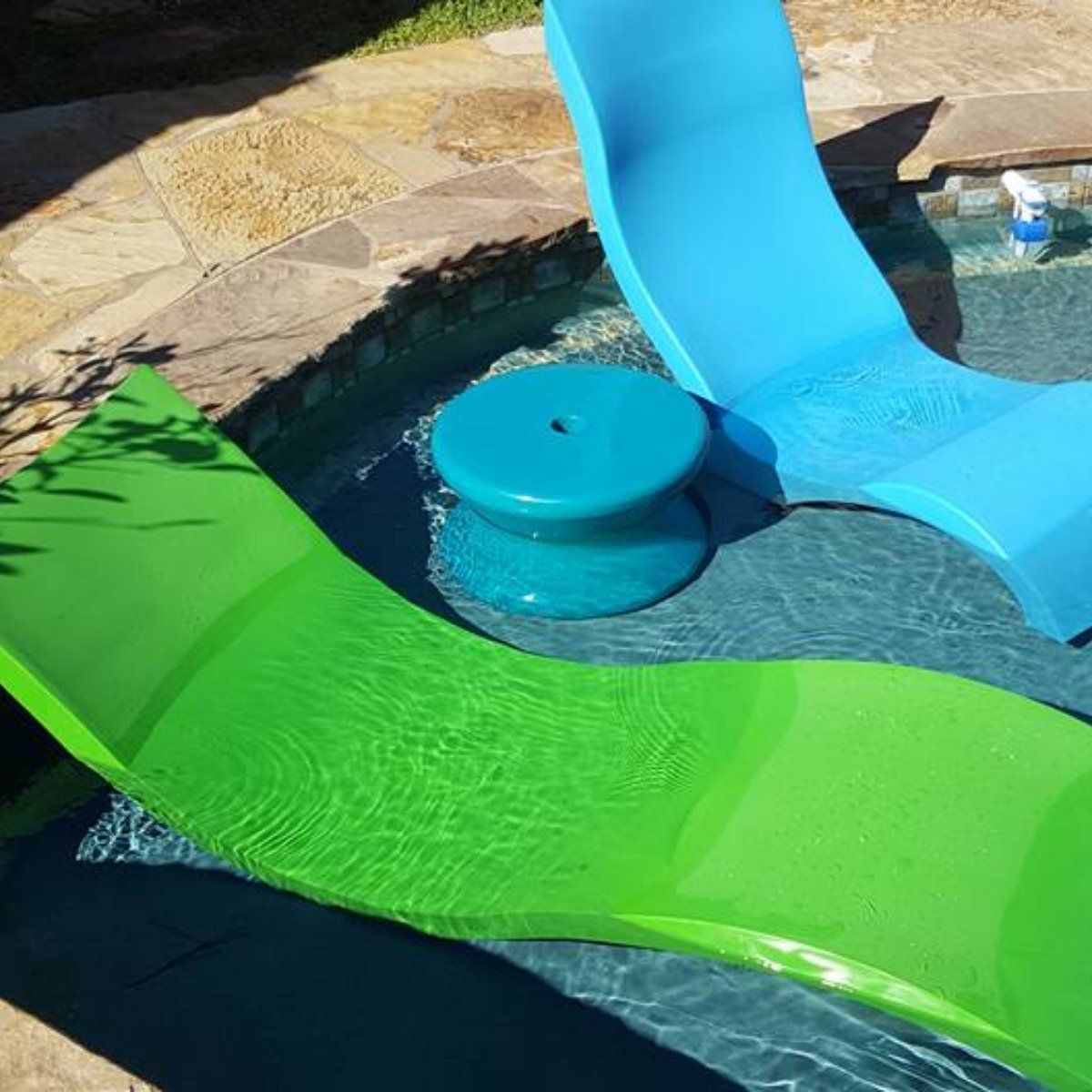 Blue and green lounge chairs in a swimming pool