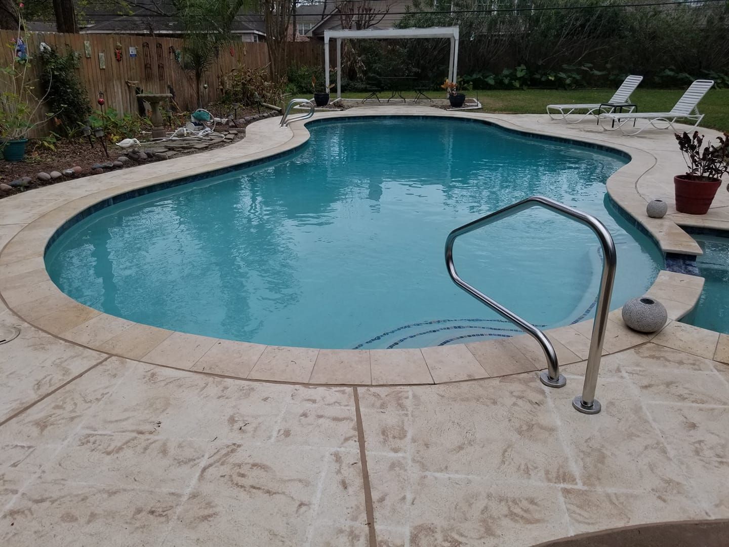 A large swimming pool with a staircase leading to it