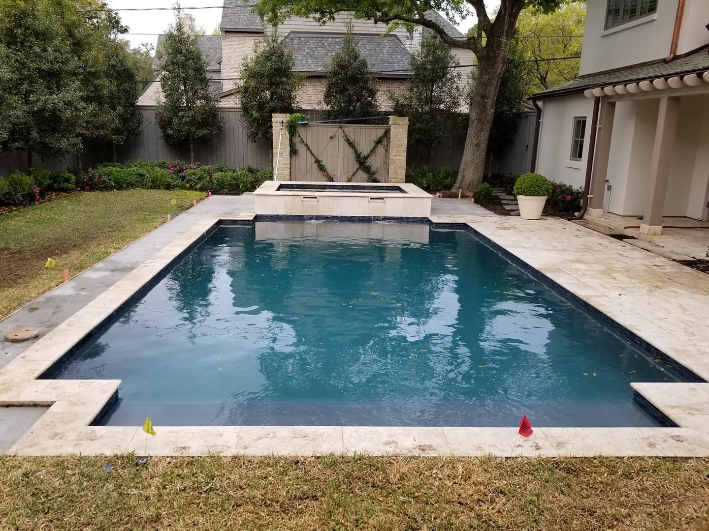 A large swimming pool in the backyard of a house