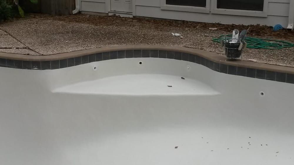 A swimming pool with a bucket on the side of it.