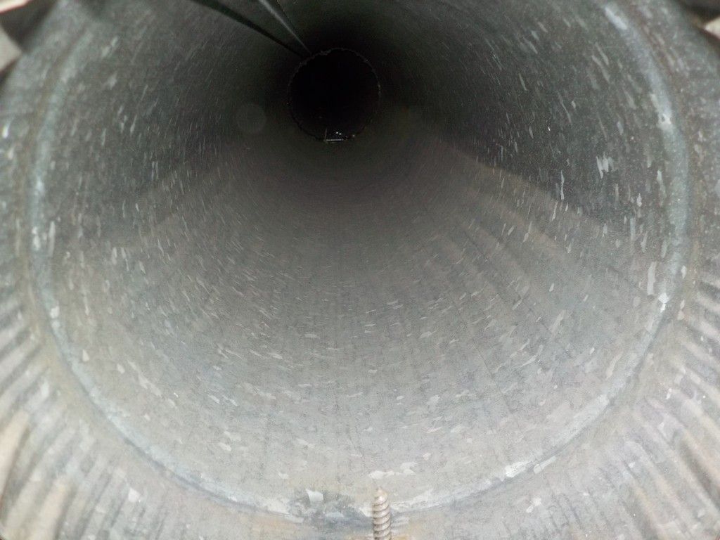 A close up of the inside of a metal pipe.
