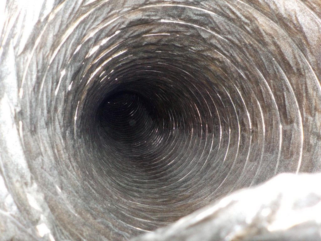 A close up of the inside of a duct with a hole in the middle.