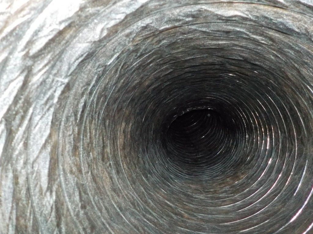 A close up of the inside of a metal pipe.