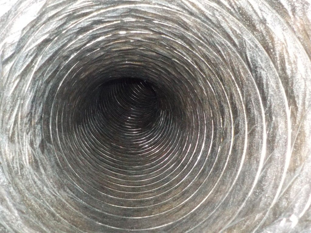 A close up of the inside of a metal duct.