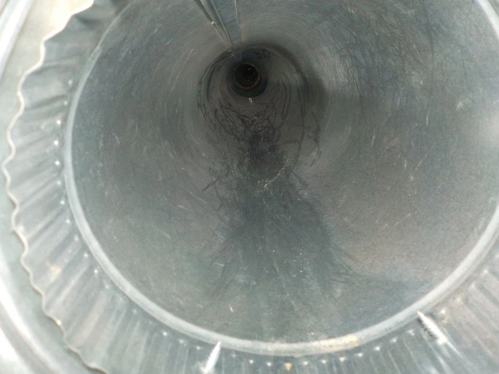 A close up of a metal pipe with a hole in the middle.