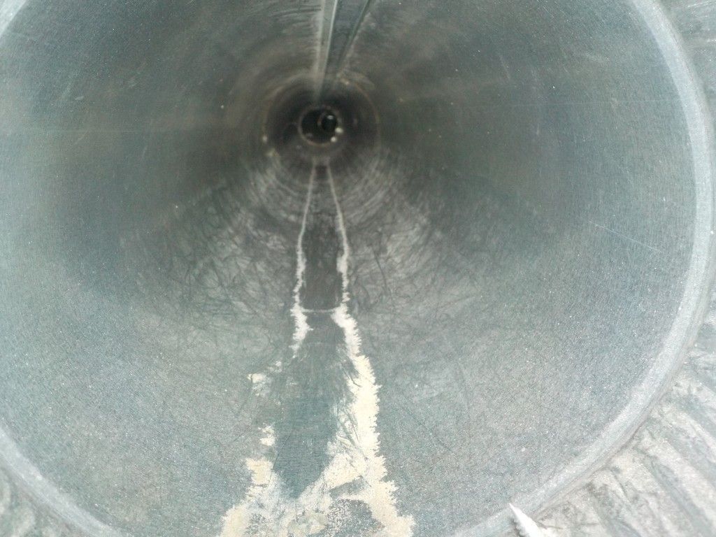 A close up of a metal pipe with a hole in the middle