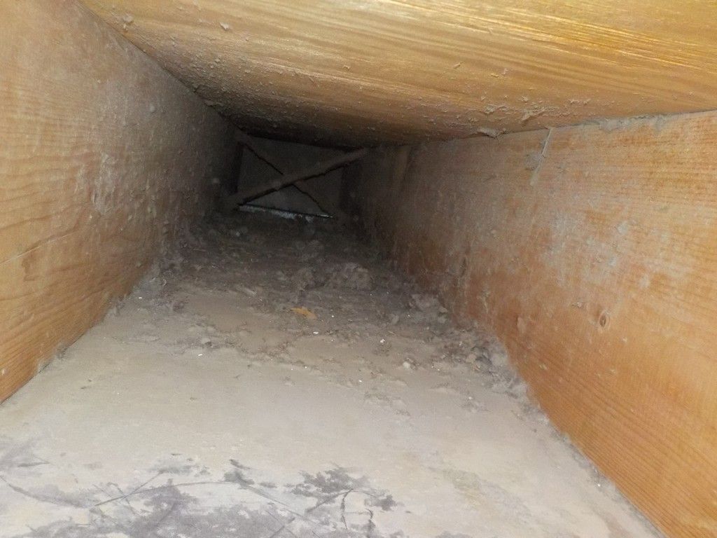 There is a hole in the wall that looks like a tunnel.