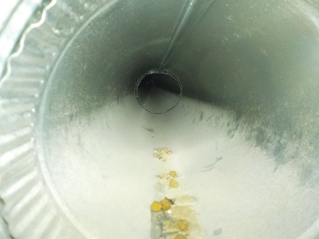 A close up of a metal pipe with a white powder on it.