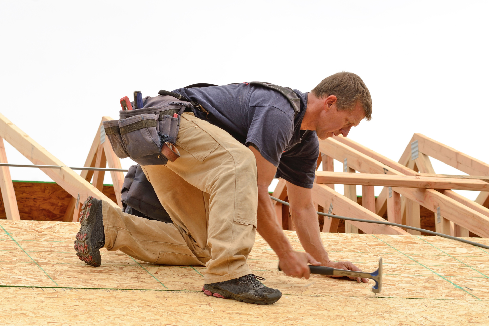 ACE worker installing a roof to be shingled shortly after