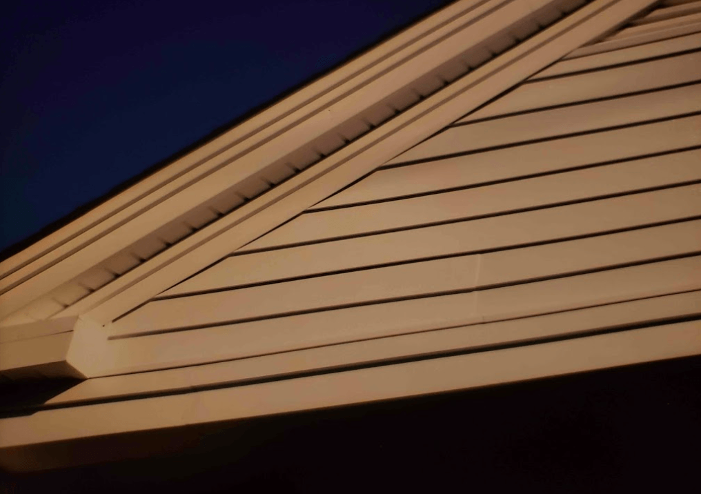 A close up of a roof with a blue sky in the background