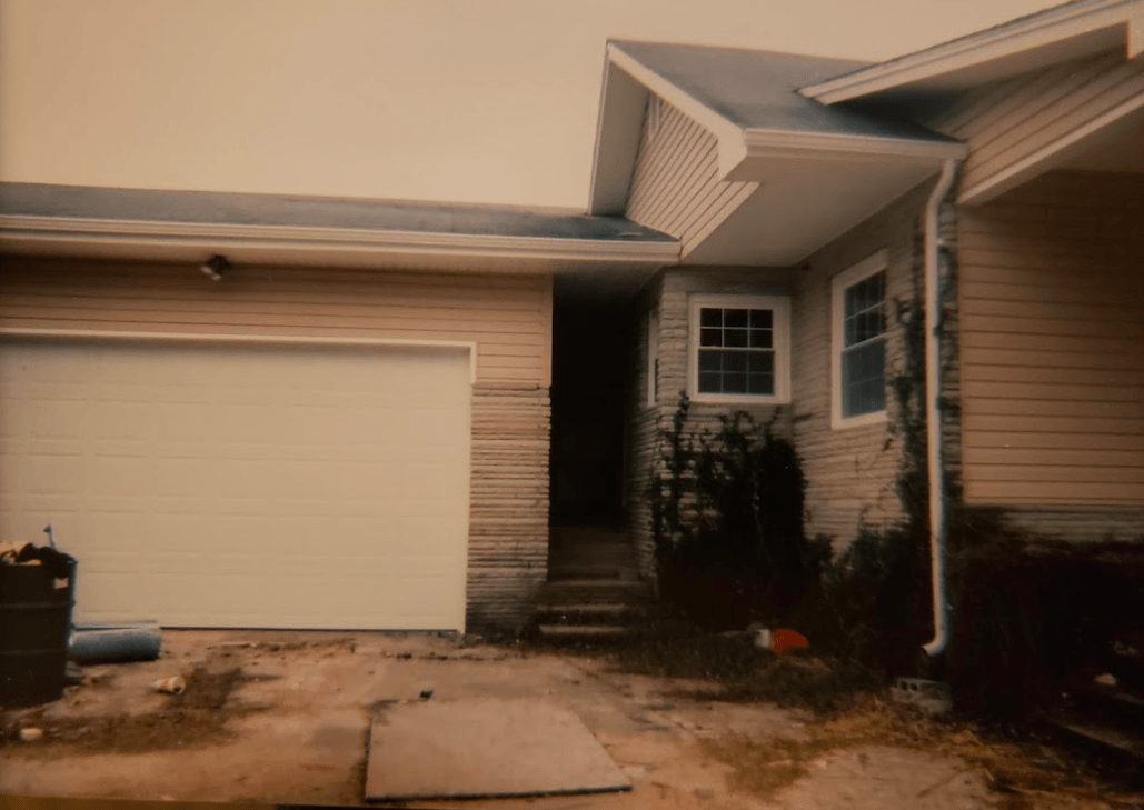 A house with a white garage door and stairs