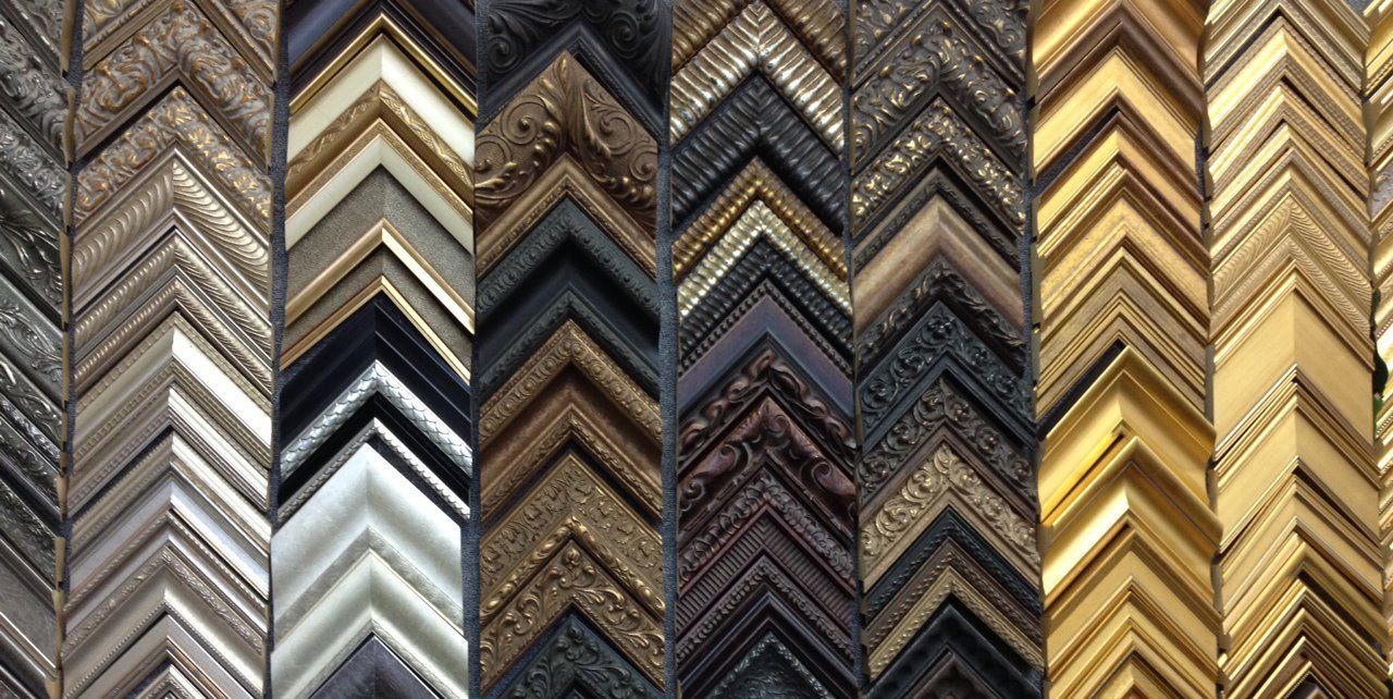 A variety of picture frames are lined up in a row.