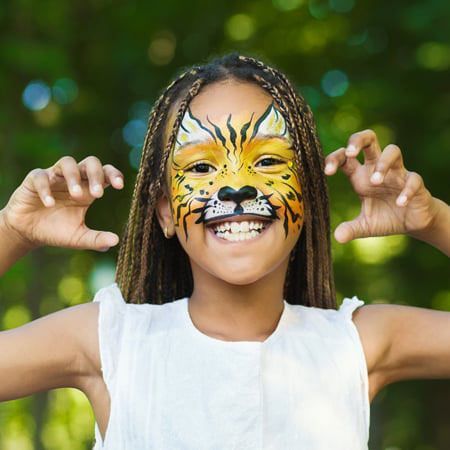 young girl with tiger face paint