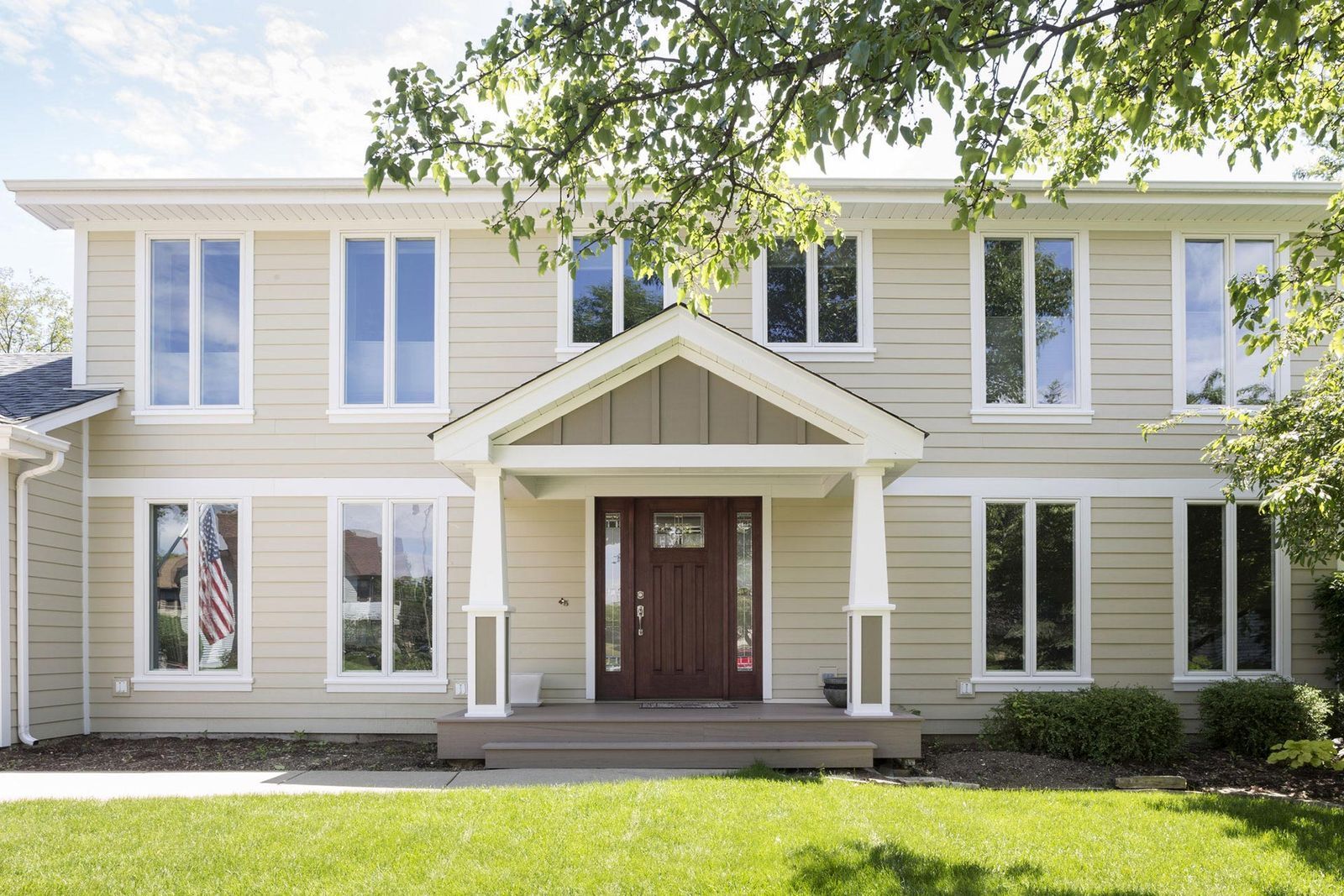 A large house with a porch and a lot of windows