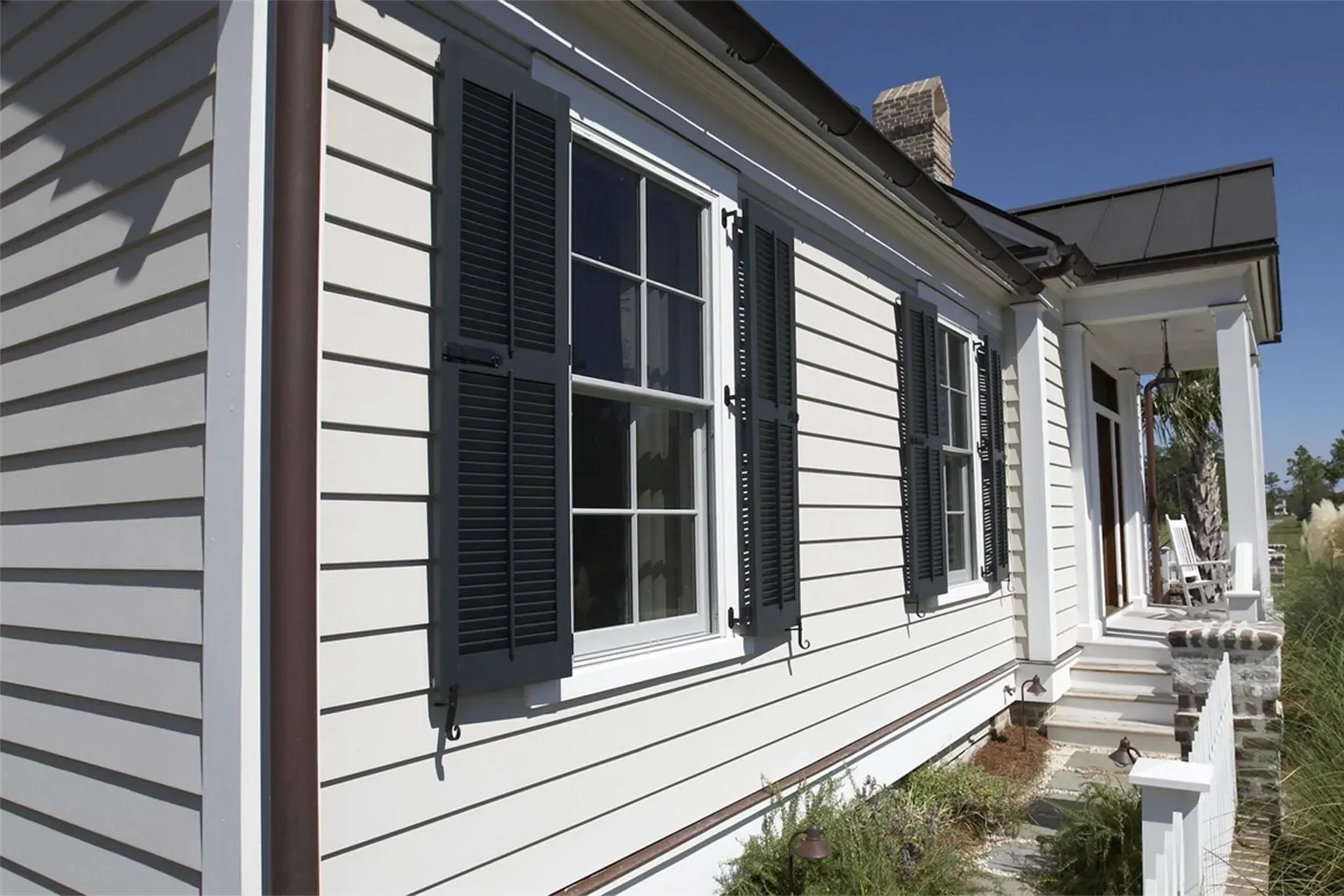 A white house with black shutters on the windows