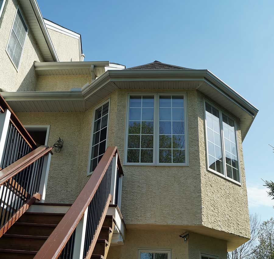A house with a lot of windows and stairs leading up to it