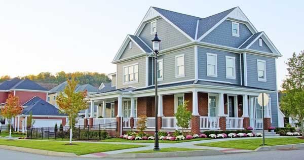 A large house with a large porch in a residential area.