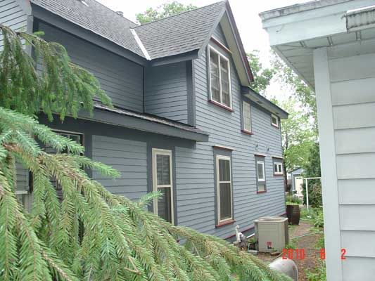 A house with a gray siding and a gray roof