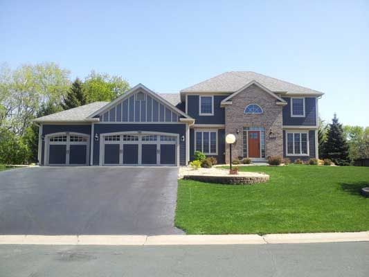 A large house with a lush green lawn in front of it