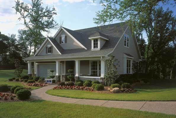 A house with a porch and a walkway leading to it
