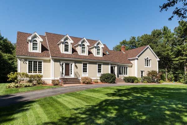 A large house with a lush green lawn in front of it