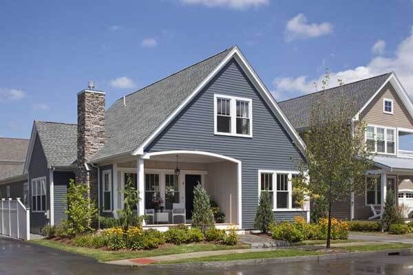 A row of houses in a residential area with a blue house in the middle