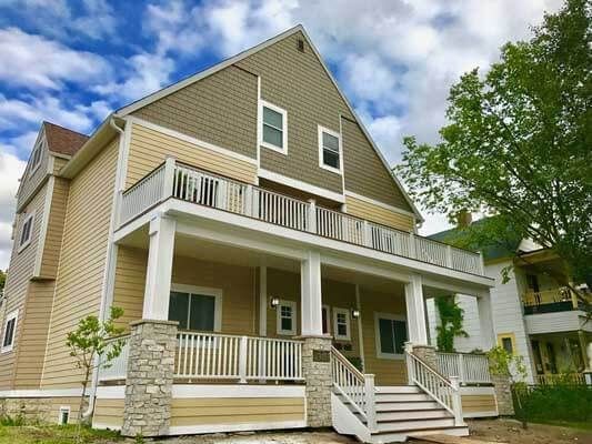 A large house with a large porch and stairs