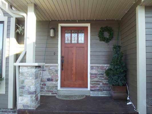 The front door of a house with a wreath on it