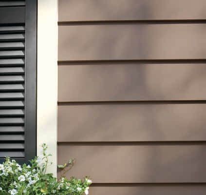 A close up of a house with a window and shutters.