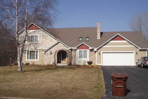 A large house with a car parked in front of it