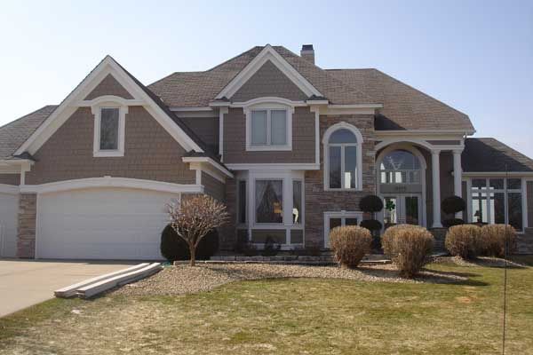 A large brick house with a white garage door