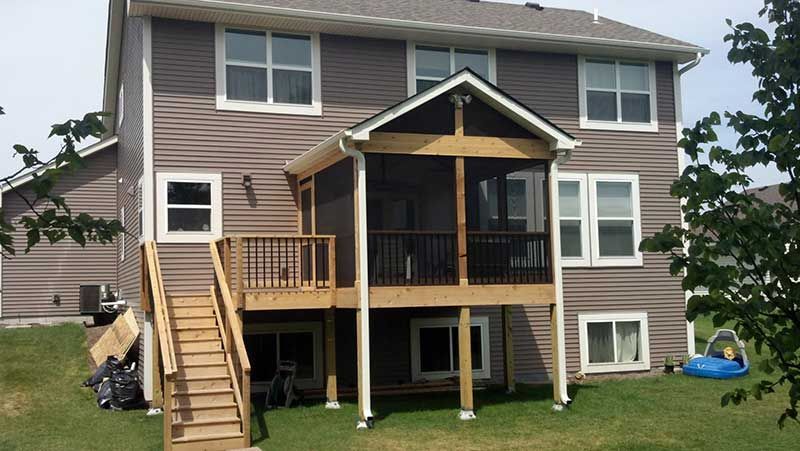 A house with a screened in porch and stairs