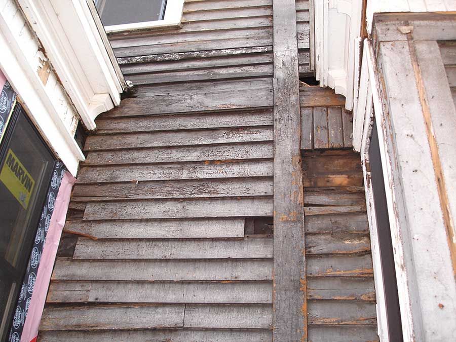 A wooden staircase leading up to a building with a window