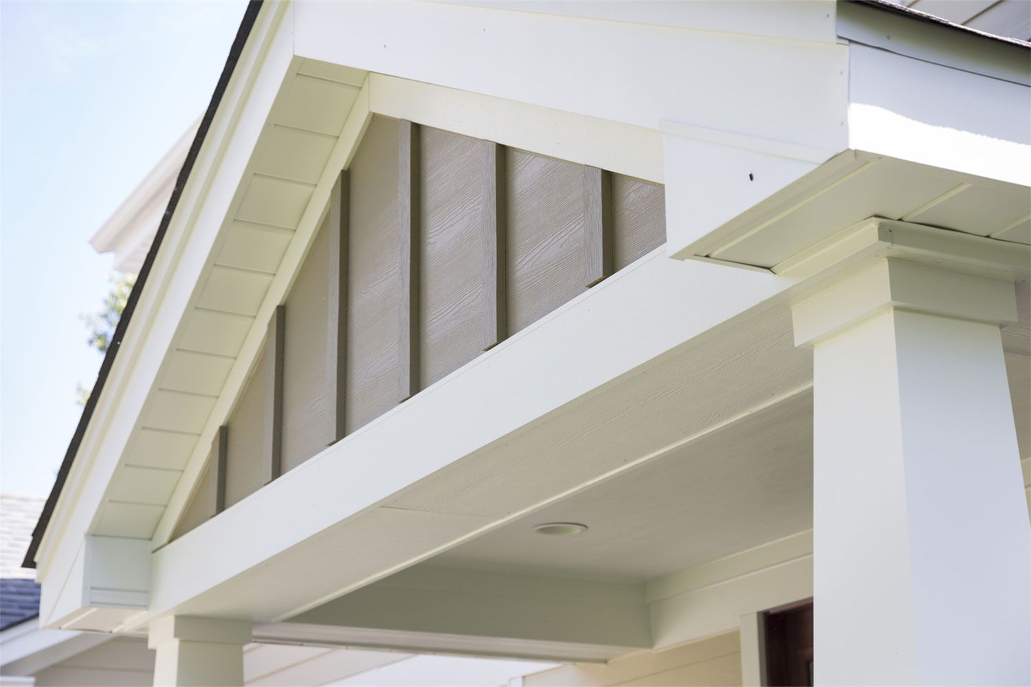 A house with a porch and a white roof
