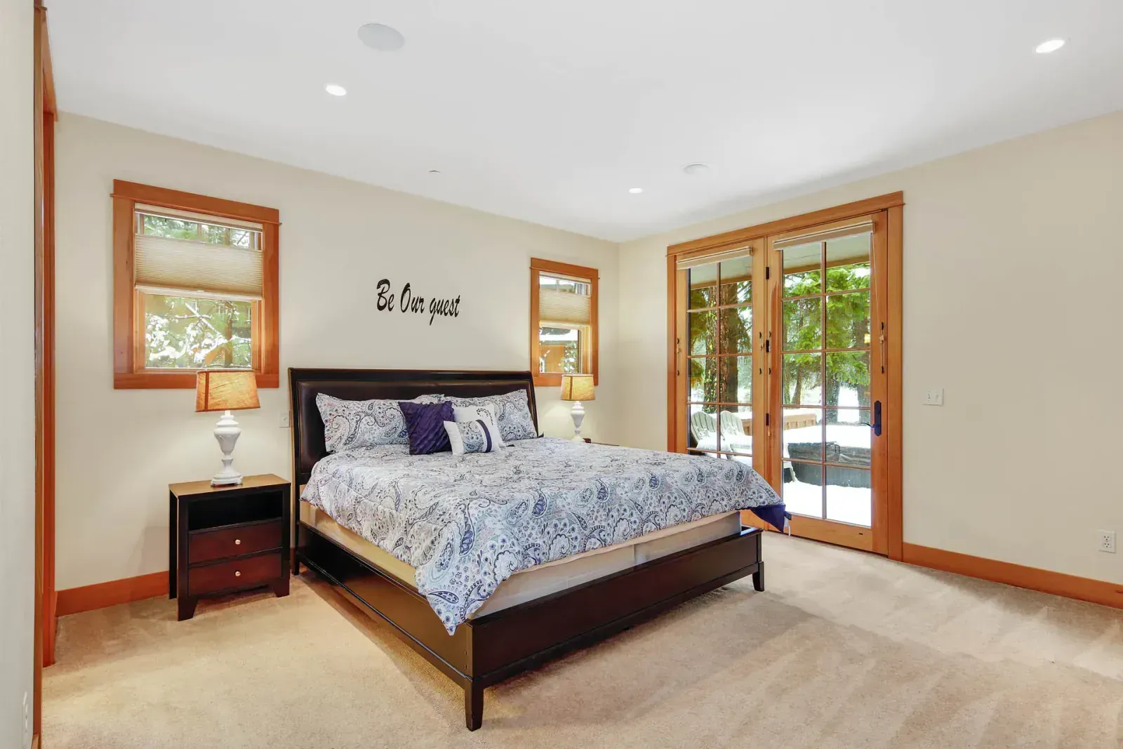 A bedroom with a large bed and a sliding glass door