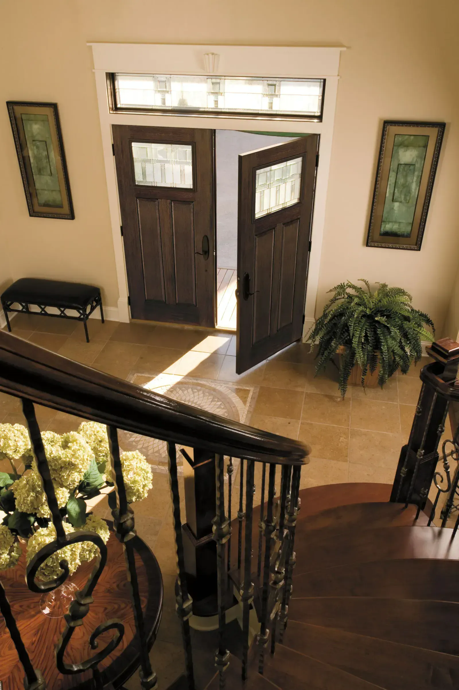A staircase leading up to a double door in a house.