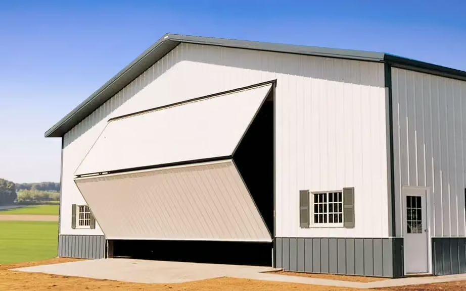 White and gray barn with a large open door, windows, and a small white door.