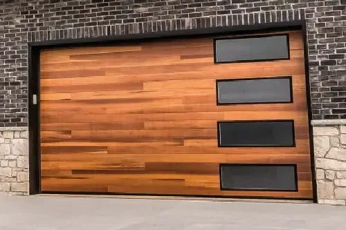 Wooden garage door with four rectangular windows and black trim.