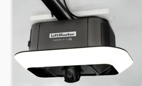 LiftMaster garage door opener with integrated camera, mounted on a ceiling. Dark gray and white.