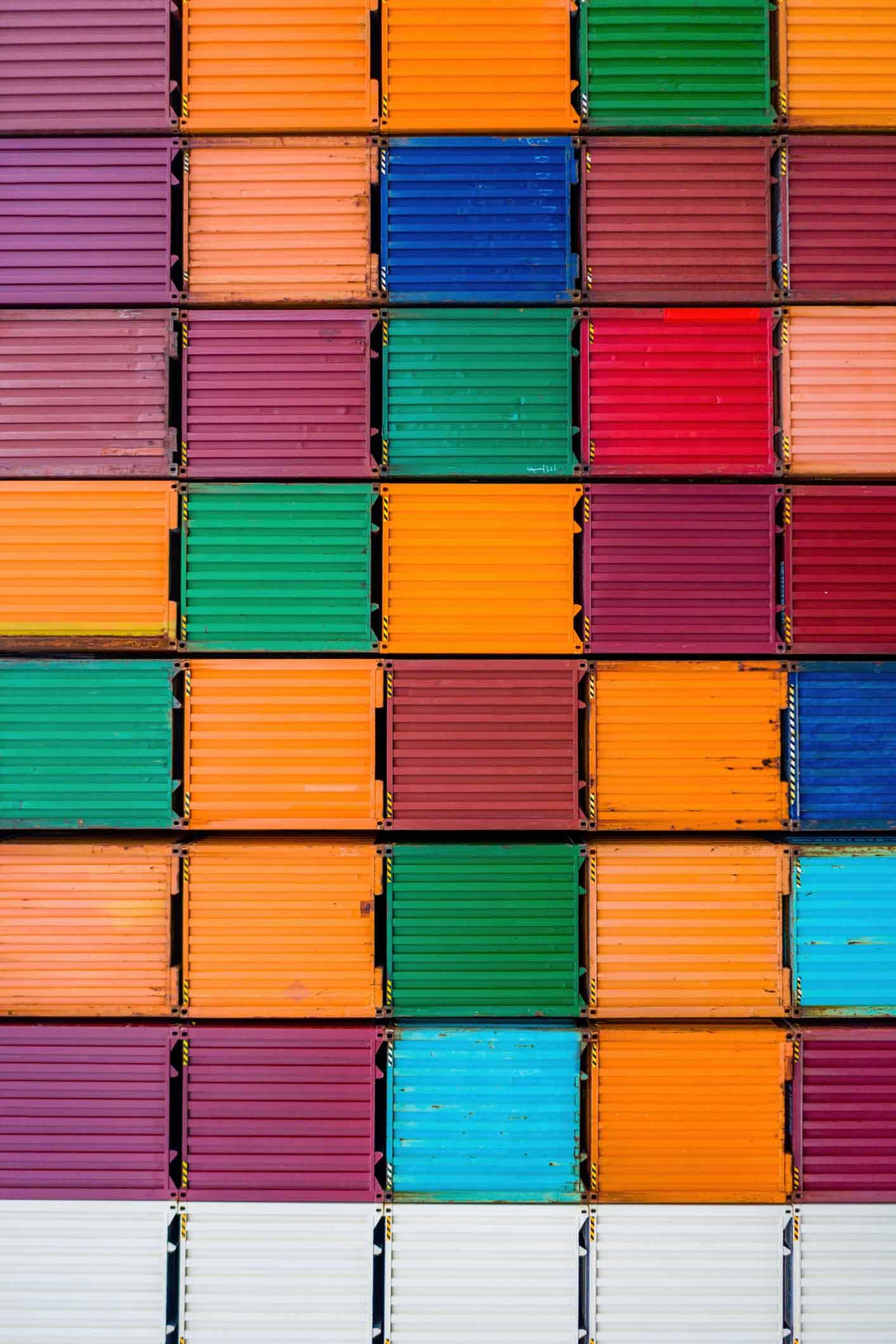 A row of colorful shipping containers stacked on top of each other.