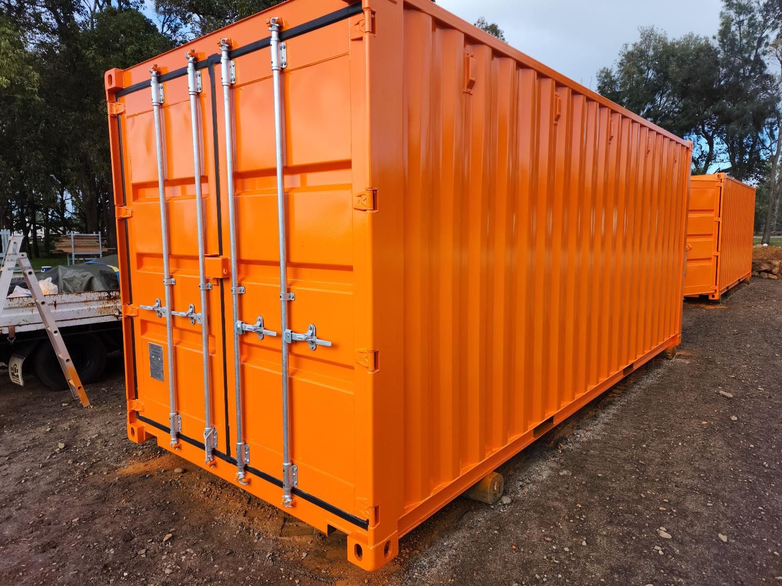 A close up of an orange shipping container.