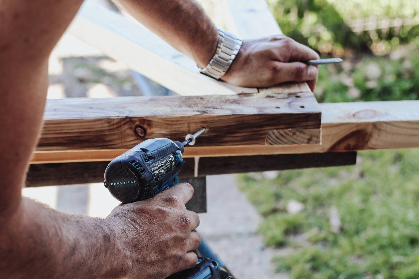 Worker Drilling Nails Into Wood — Home Improvement Services in Maitland, NSW