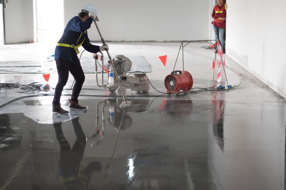 Person Using a Floor Grinder in a Large Room — On The Grind In Bongaree, QLD